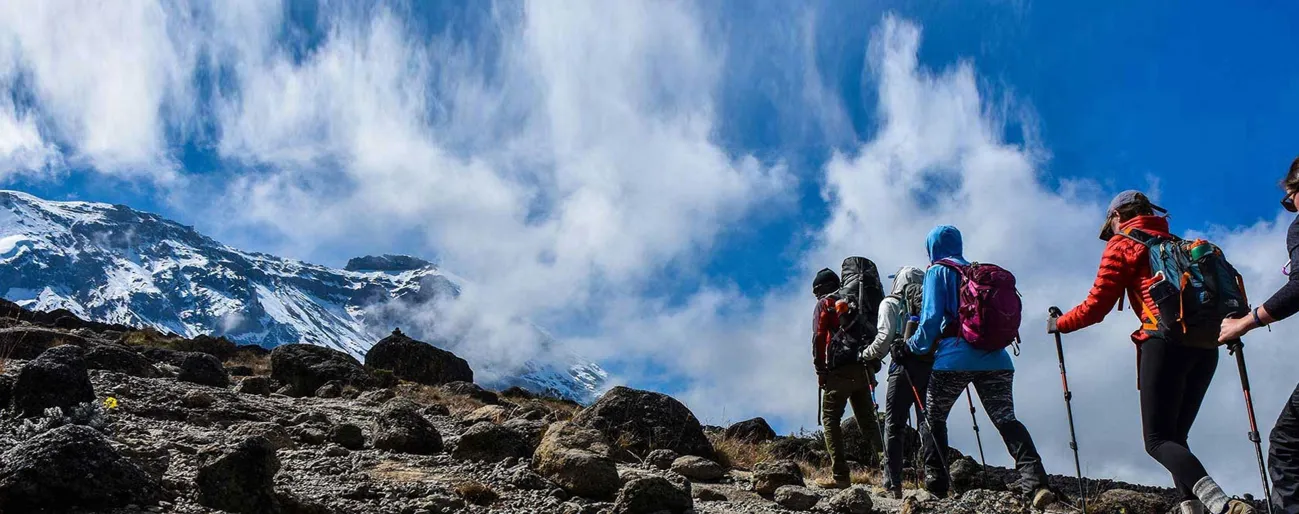 Trekkers walking toward the ice capped summit of Mount Kilimanjaro in Tanzania